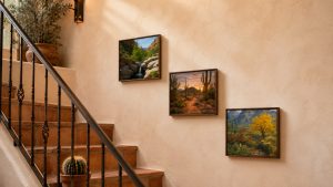 Three prints follow the stairway’s angle, turning a transition space into a gallery walk.